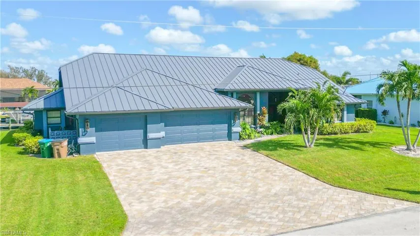 View of front of home featuring a front lawn and a garage