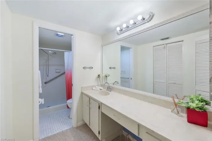 Primary-bathroom with long vanity and walk in shower.