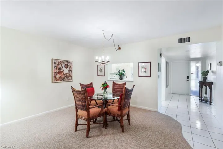 Dining room featuring a chandelier and light carpet
