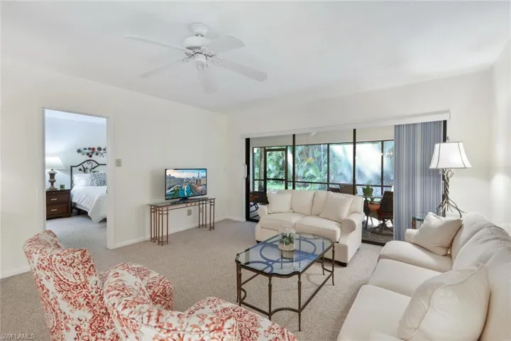 Living room with entrance to the primary-bedroom and back lania
