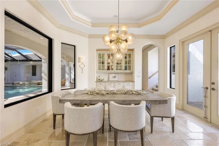 Formal Dining room with built in hutch and opens to garden patio with fountain