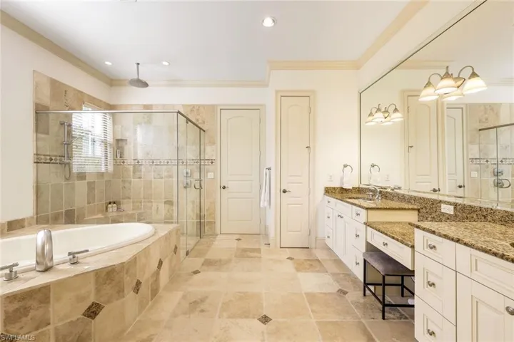 Walk in glass shower and jetted tub with two walk in closets.