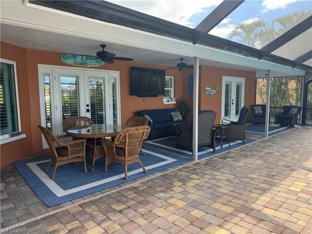 Prior to Hurricane  Helene  View of patio / terrace with french doors, a lanai, an outdoor hangout area, and ceiling fan