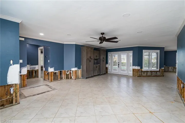 living room featuring ornamental molding, french doors, and ceiling fan
