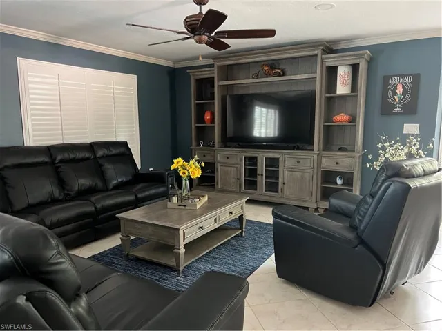 Prior to Hurricane  Helene Living room featuring ornamental molding and ceiling fan