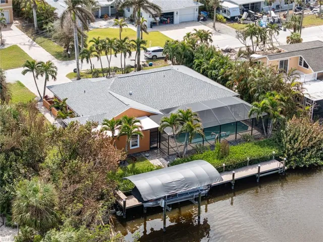 Birds eye view of property with a water view