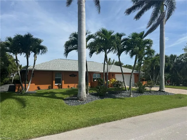 Prior to Hurricane  Helene  View of front of home with a front lawn and a garage