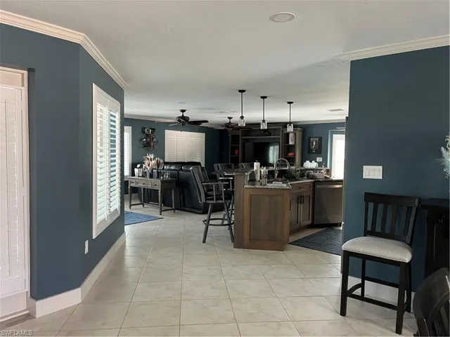 Prior to Hurricane  Helene Kitchen featuring ornamental molding, decorative light fixtures, a healthy amount of sunlight, and dishwashing machine