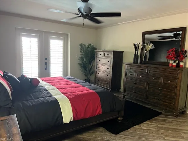 Prior to Hurricane  Helene Primary Bedroom with ornamental molding, tile  flooring, and ceiling fan