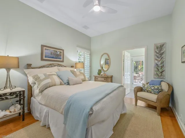 Bedroom with light wood-style flooring, baseboards, visible vents, and ceiling fan