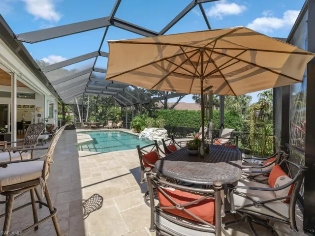 Outdoor pool with outdoor dining area, a patio, and a lanai
