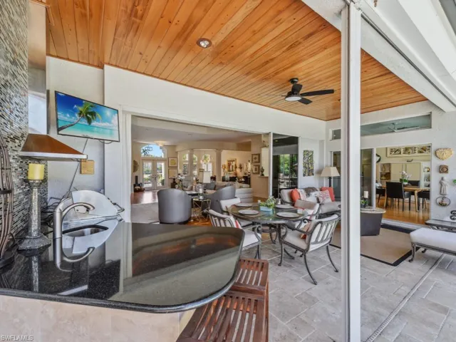 View of patio featuring outdoor dining area, ceiling fan, and french doors