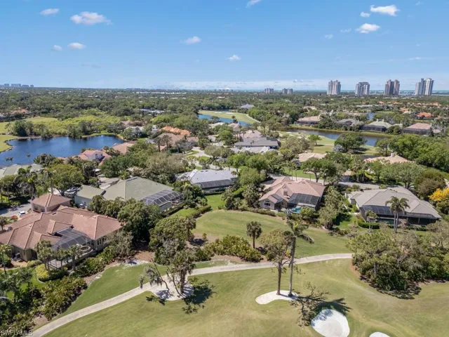 Drone / aerial view featuring a residential view, golf course view, and a water view