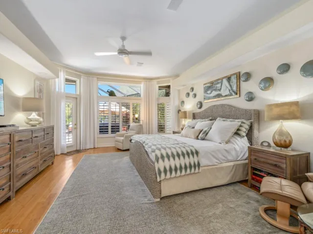 Bedroom with access to outside, light wood-style floors, and ceiling fan