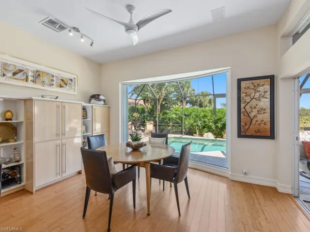 Dining room featuring light wood-style flooring, a ceiling fan, visible vents, and baseboards
