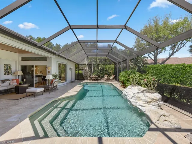 Outdoor pool with a lanai and a patio