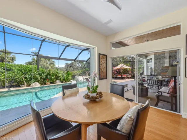 Dining room with light wood-type flooring and a sunroom