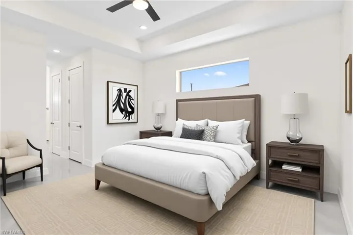 Bedroom featuring ceiling fan, recessed lighting, and a tray ceiling