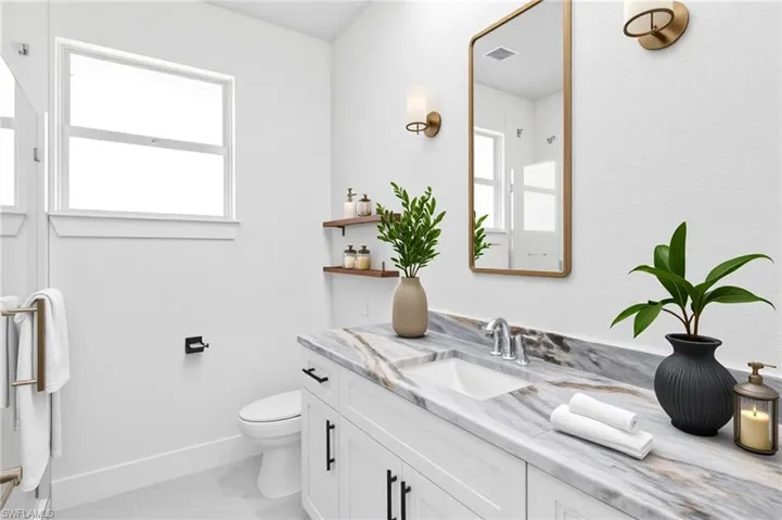 Bathroom featuring vanity and baseboards