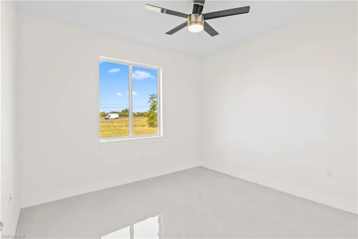 Unfurnished room featuring a ceiling fan