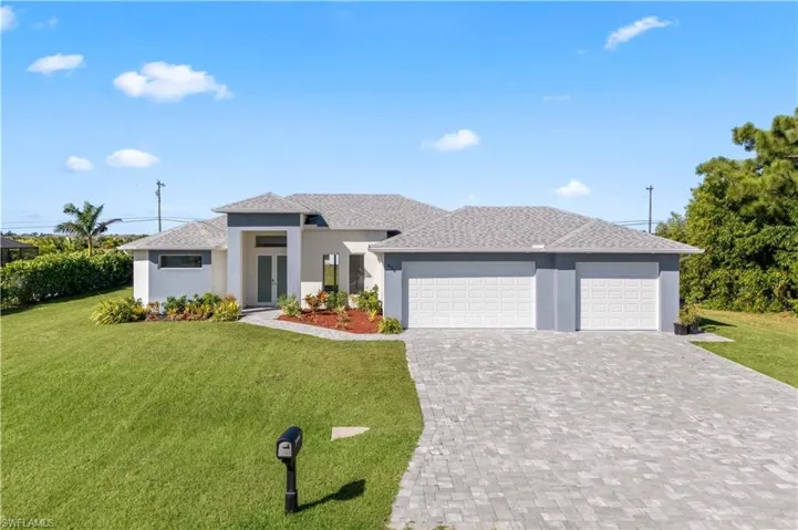 Prairie-style house with a front lawn, an attached garage, stucco siding, decorative driveway, and roof with shingles