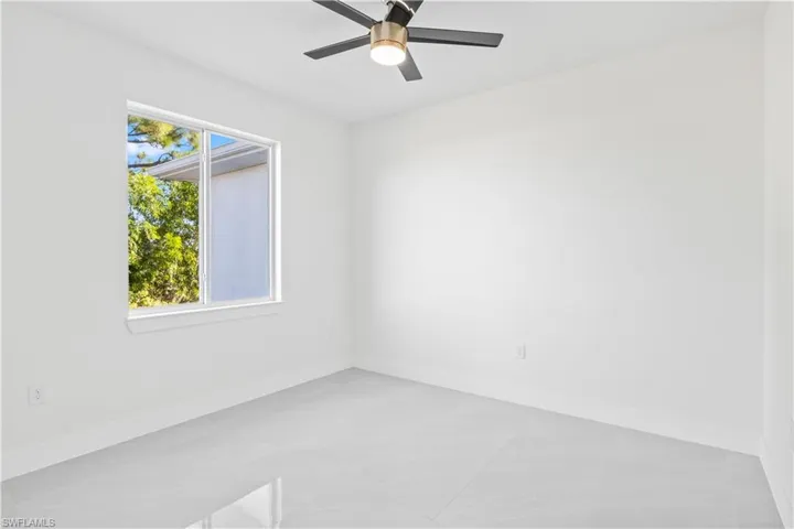 Spare room featuring baseboards and a ceiling fan