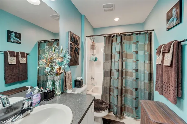 Full bathroom with vanity and shower / bathtub combination with curtain