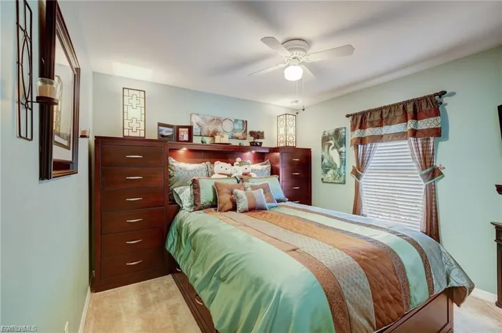 Bedroom featuring light colored carpet and ceiling fan