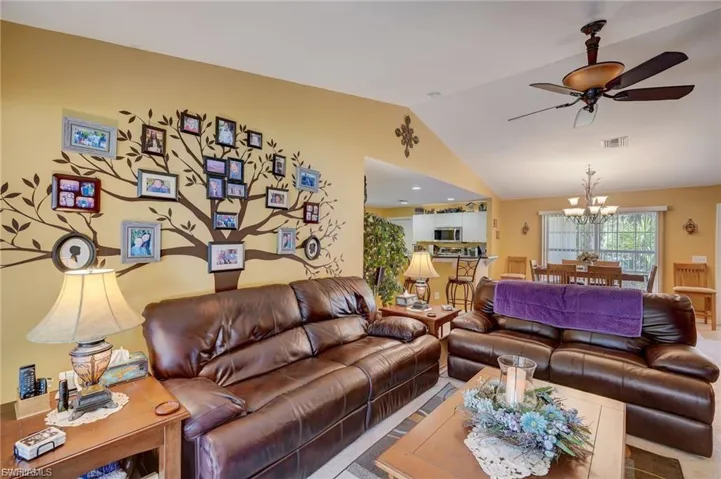 Living area featuring a ceiling fan and suspended lighting