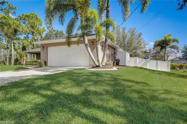 View of front of house with a garage, stucco siding, and concrete driveway