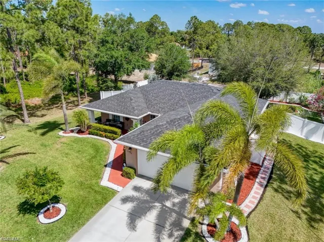 View from above of property with a tree filled landscape