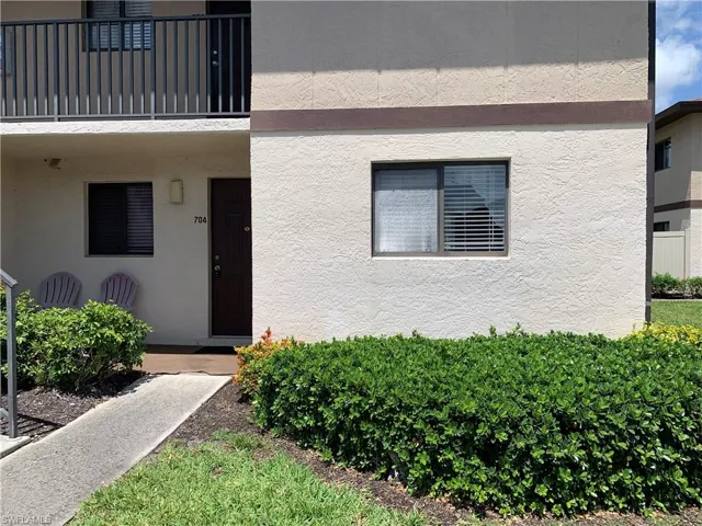 View of first floor exterior entry with stucco siding