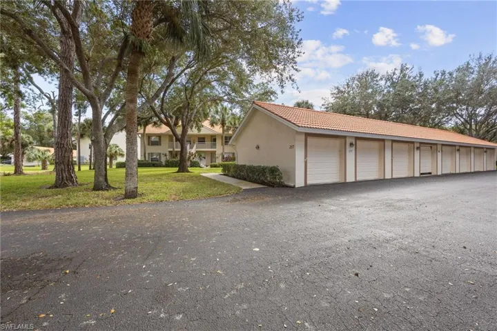 View of garage from parking lot, condo in the distance