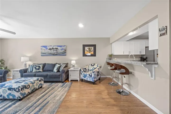 Living room with seating at kitchen bar