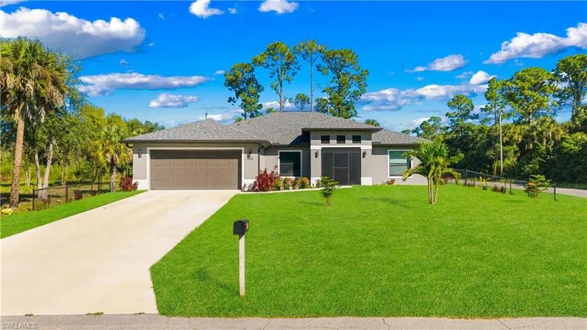 Prairie-style home with stucco siding, concrete driveway, an attached garage, and a shingled roof