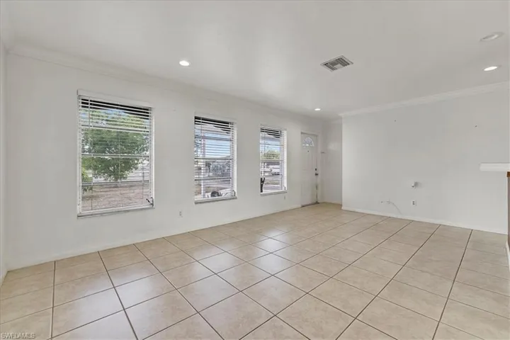 Unfurnished room with plenty of natural light, ornamental molding, and recessed lighting