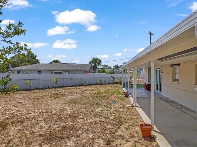 View of yard with a patio and fence