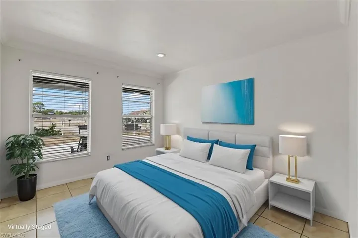 Tiled bedroom featuring baseboards and ornamental molding