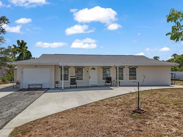 Ranch-style house featuring driveway, a garage, stucco siding, a shingled roof, and a porch