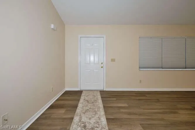 Entrance foyer with dark hardwood / wood-style floors