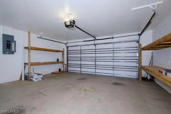 Garage with a garage door opener and electric panel