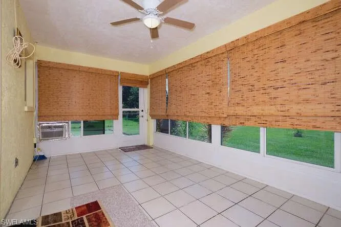 Unfurnished sunroom with ceiling fan