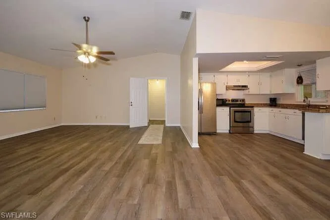 Kitchen featuring white cabinets, appliances with stainless steel finishes, dark hardwood / wood-style floors, and ceiling fan