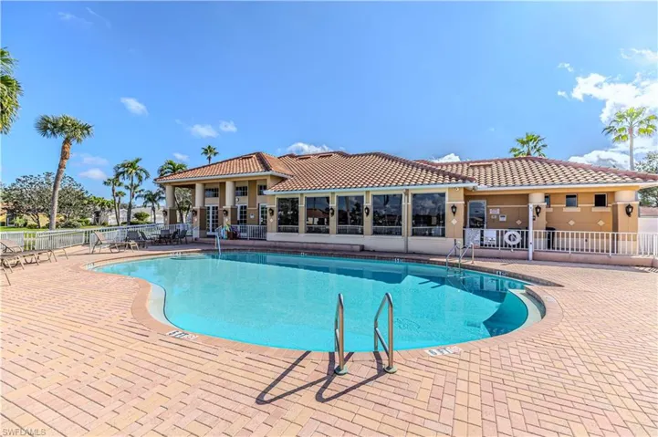 View of community swimming pool featuring a patio area