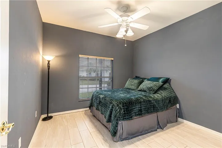 Front bedroom featuring ceiling fan and woodlike tile floors