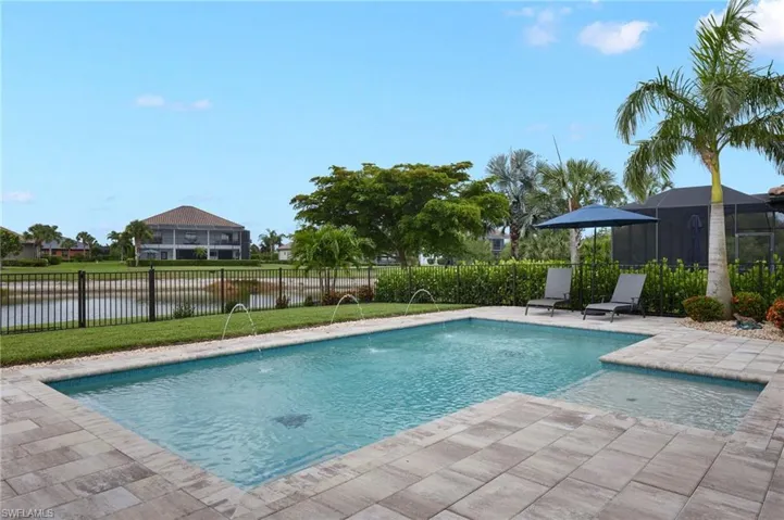 View of pool featuring a water view and a patio