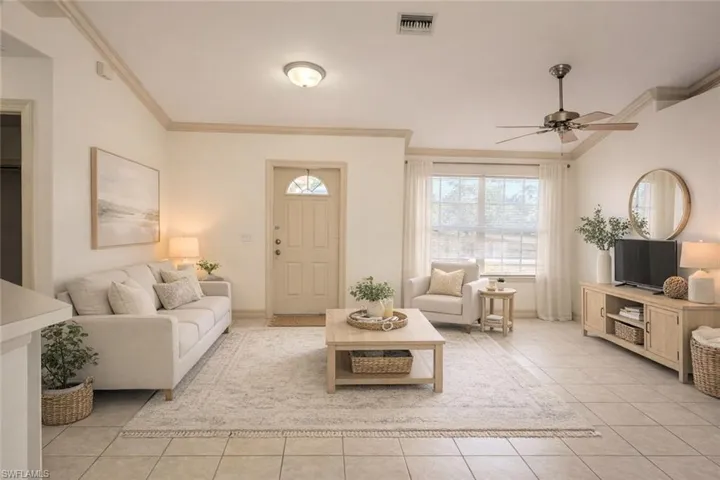 Virtual staged entry and Living room featuring crown molding, a ceiling fan, and light tile patterned floors