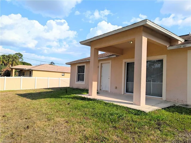 Rear view of property with a patio and stucco siding