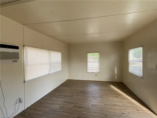 Spare room featuring wood finished floors and healthy amount of natural light