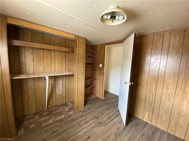 Unfurnished bedroom with wood finished floors